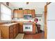 Kitchen with vintage cabinets, stainless microwave and a red accent kettle at 2002 Fisher Ave, Indianapolis, IN 46224