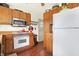 Kitchen with wooden cabinets and a white refrigerator at 2002 Fisher Ave, Indianapolis, IN 46224