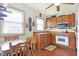 Eat-in kitchen featuring wood cabinets, a vintage range, and a ceiling fan at 2002 Fisher Ave, Indianapolis, IN 46224