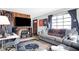 Inviting living room featuring a comfortable gray sofa, large window, and themed decor at 2002 Fisher Ave, Indianapolis, IN 46224