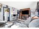 Inviting living room featuring a comfortable gray sofa, large tv, and themed decor at 2002 Fisher Ave, Indianapolis, IN 46224