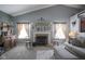 Cozy living room with a fireplace, stylish decor, and ample natural light from the windows at 2167 Meridian Springs Ln, Greenfield, IN 46140