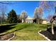 Spacious backyard with lush lawn, mature trees, and a screened-in porch, ideal for outdoor relaxation at 226 Sandbrook Cir, Noblesville, IN 46062