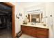 Bathroom with wood cabinets, carpet flooring, and large mirror at 226 Sandbrook Cir, Noblesville, IN 46062