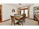 Dining area featuring a wooden table, six chairs, and view to outdoor space through sliding glass door at 226 Sandbrook Cir, Noblesville, IN 46062