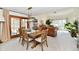 Open-concept dining area with a wooden table, six chairs, and a sliding door to the outside at 226 Sandbrook Cir, Noblesville, IN 46062