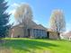 Beautiful one-story home featuring a screened porch, surrounded by lush green lawns and mature trees at 226 Sandbrook Cir, Noblesville, IN 46062