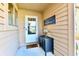 Inviting front entrance featuring a storm door, welcome sign, and a side table with decorative lamp at 226 Sandbrook Cir, Noblesville, IN 46062