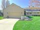 Inviting home featuring a lush front lawn, complemented by a charming white bench and a two-car garage at 226 Sandbrook Cir, Noblesville, IN 46062