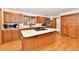 A cozy kitchen with wooden cabinets, an island with cooktop and stainless steel appliances at 226 Sandbrook Cir, Noblesville, IN 46062