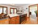 View of island with cooktop in kitchen, opening to dining area and a glimpse of the living room at 226 Sandbrook Cir, Noblesville, IN 46062