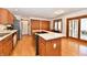 Well-lit kitchen with wood cabinets, stainless steel appliances, and an island with a cooktop at 226 Sandbrook Cir, Noblesville, IN 46062