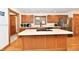 A cozy kitchen with wooden cabinets, an island with cooktop and stainless steel appliances at 226 Sandbrook Cir, Noblesville, IN 46062