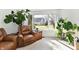Comfortable chair in naturally lit living room that features plants and a view to outdoor space at 226 Sandbrook Cir, Noblesville, IN 46062