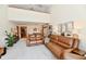 Spacious living room with open layout featuring leather sofas, vaulted ceilings, and an open flow to dining area at 226 Sandbrook Cir, Noblesville, IN 46062