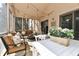 Cozy screened porch with comfortable seating, string lights, and ample space for entertaining at 226 Sandbrook Cir, Noblesville, IN 46062