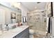 Modern bathroom with a marble vanity, tiled shower with glass door, and updated fixtures at 2456 N Willow Way, Indianapolis, IN 46268