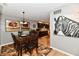Warm dining area with dark wood table, seating for six, and view into the modern kitchen at 2456 N Willow Way, Indianapolis, IN 46268