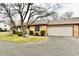 Charming brick home with a well-manicured lawn, mature trees, and an attached two-car garage at 2456 N Willow Way, Indianapolis, IN 46268