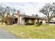 Attractive brick exterior with well-kept landscaping, a stone bench, and a paved walkway at 2456 N Willow Way, Indianapolis, IN 46268