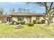 Charming single-story home featuring a brick facade, well-maintained landscaping, and inviting front porch at 2456 N Willow Way, Indianapolis, IN 46268