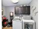 Functional laundry room with modern washer and dryer, built-in cabinets, and ample storage space at 2456 N Willow Way, Indianapolis, IN 46268