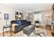 Cozy living room featuring a comfortable sofa, accent pillows, modern art, and a bright window at 2456 N Willow Way, Indianapolis, IN 46268