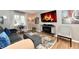 Modern living room with a gray sofa, electric fireplace, and a large flat screen TV at 2456 N Willow Way, Indianapolis, IN 46268