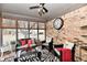 Bright sunroom with brick walls, a ceiling fan, ample seating, and windows that let in plenty of natural light at 2456 N Willow Way, Indianapolis, IN 46268