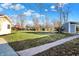 A grassy backyard featuring a brick walkway and a wooden playground at 3011 S 550 W, Columbus, IN 47201