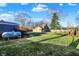 A spacious backyard with a propane tank and a wooden swing set at 3011 S 550 W, Columbus, IN 47201