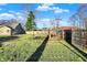 A grassy backyard with a wooden swing set and a fenced perimeter at 3011 S 550 W, Columbus, IN 47201