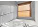 Bright bathroom view showcasing a modern tub with chrome fixtures and wood blinds at 3011 S 550 W, Columbus, IN 47201