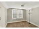 Carpeted room with natural light from a window, complete with a sleek floor lamp at 3011 S 550 W, Columbus, IN 47201