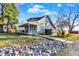 Lovely home featuring mature trees and a charming exterior with a covered porch, a welcoming view from the drive at 3011 S 550 W, Columbus, IN 47201