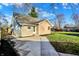 An exterior side view of a house with a driveway and grassy backyard at 3011 S 550 W, Columbus, IN 47201