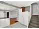 Open-concept kitchen with modern appliances, and an adjacent staircase offering functionality and charm at 3011 S 550 W, Columbus, IN 47201