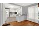 Well-lit kitchen features white cabinets, modern appliances, and an eat-in bar, maximizing space and style at 3011 S 550 W, Columbus, IN 47201
