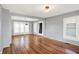 Bright and airy living room featuring hardwood floors, neutral paint, and large windows, offering a cozy vibe at 3011 S 550 W, Columbus, IN 47201