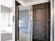 Sleek shower featuring dark hexagon tiles and glass door at 3011 S 550 W, Columbus, IN 47201