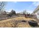 The spacious backyard is surrounded by a white picket fence and has a seating area on a raised wooden deck at 3121 River Birch Dr, Indianapolis, IN 46235