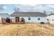 The backyard is surrounded by a white picket fence, and has a raised wooden deck area with sliding door access into the house at 3121 River Birch Dr, Indianapolis, IN 46235