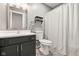 This bathroom features a vanity with a dark cabinet, a large mirror, and a shower with a white shower curtain at 3121 River Birch Dr, Indianapolis, IN 46235