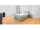 Cozy bedroom with a comfortable bed, hardwood floors and a side table at 3121 River Birch Dr, Indianapolis, IN 46235