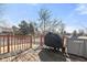 The wooden deck has a grill covered with a dark fabric and a table with a gray cover at 3121 River Birch Dr, Indianapolis, IN 46235
