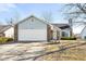 Charming home with a two-car garage, brick accents, light blue vinyl siding, and a well-manicured front yard at 3121 River Birch Dr, Indianapolis, IN 46235