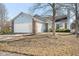Charming home with a two-car garage, brick accents, light blue vinyl siding, and a well-manicured front yard at 3121 River Birch Dr, Indianapolis, IN 46235