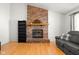 Close-up view of a brick fireplace with a wooden mantel, complementing the hardwood floors at 3121 River Birch Dr, Indianapolis, IN 46235