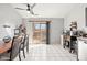 Spacious eat-in kitchen area with sliding glass doors and bright tile flooring at 3121 River Birch Dr, Indianapolis, IN 46235