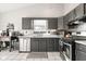 Charming kitchen with gray cabinets, stainless steel appliances, and tile backsplash at 3121 River Birch Dr, Indianapolis, IN 46235